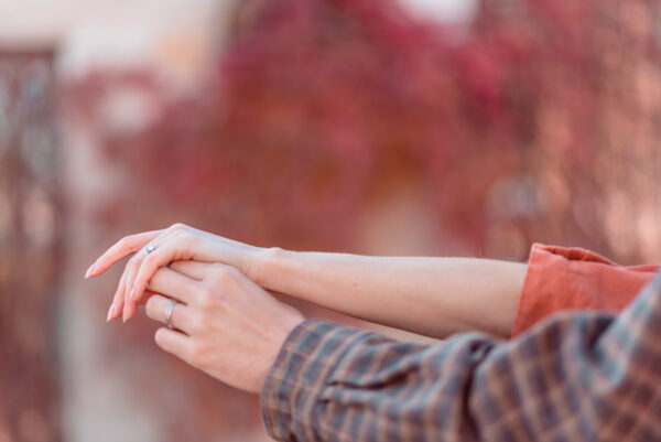 Dreamy romanticised detail photo of couple holding hands during couple photoshoot in Bucharest